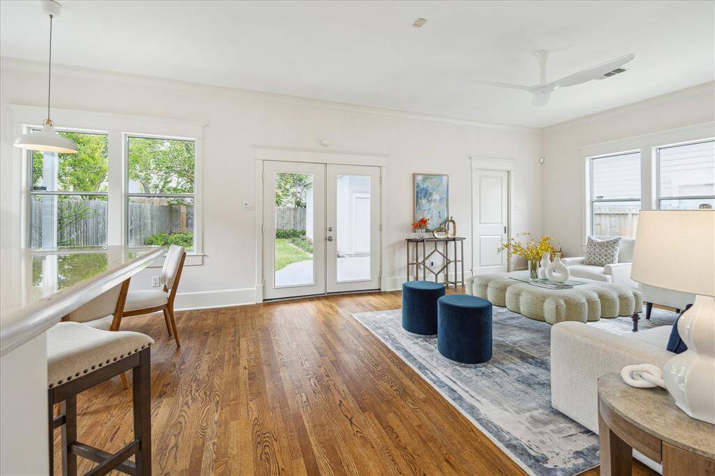 Double doors open to the covered patio off the den.