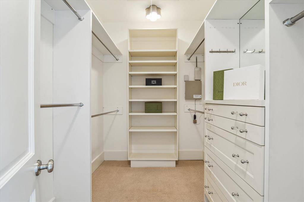 Primary bedroom walk-in closet with built-ins.
