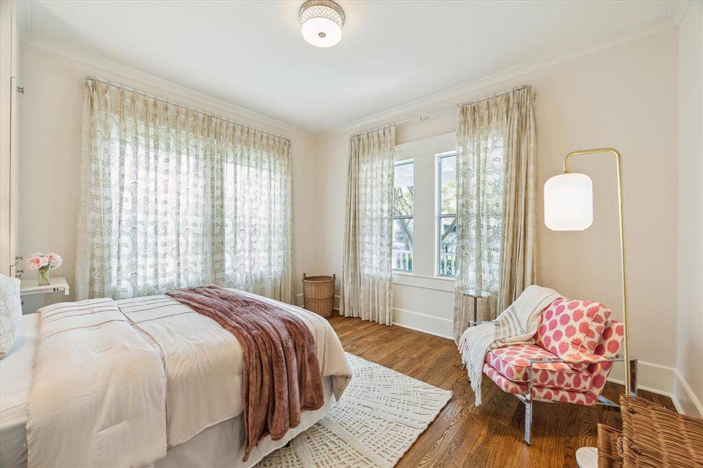 The light filled secondary bedroom at the front of the house has two sets of double windows.