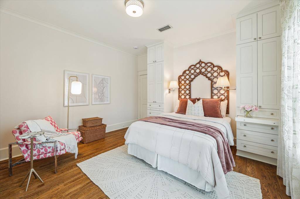 A bed alcove with build-in storage and pull shelves is located on one wall in the secondary bedroom.