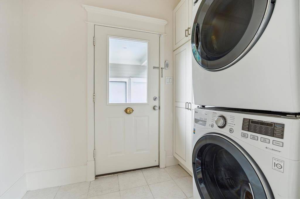 The laundry/mud room with a back door opening to the covered walkway to the garage.