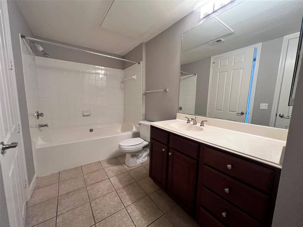 The secondary bathroom is accessible from the hallway and the secondary bedroom. Enjoy the large soaking tub and lots of counter and storage space.