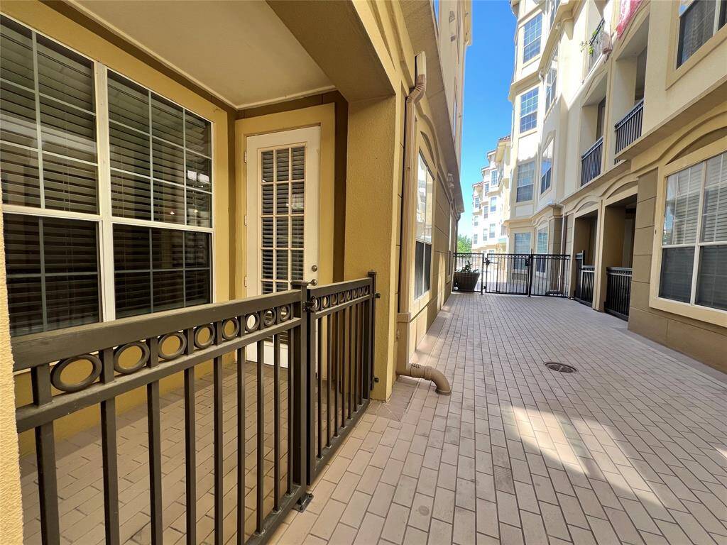 This view shows the side patio off the dining area. Walk out the gate and directly to the pool.