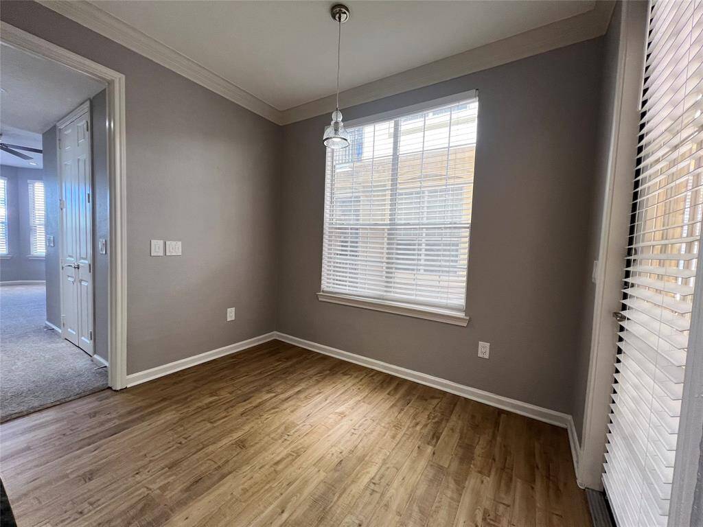 The dining area is off of the kitchen. The door goes out onto a small patio. There is a walkway tht leads directly to the pool.