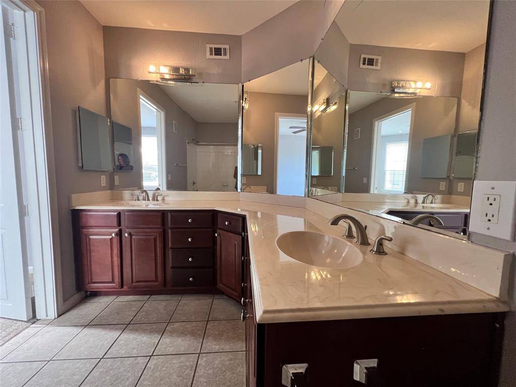 The primary bathroom has double sinks, lots of counter space and plenty of storage.