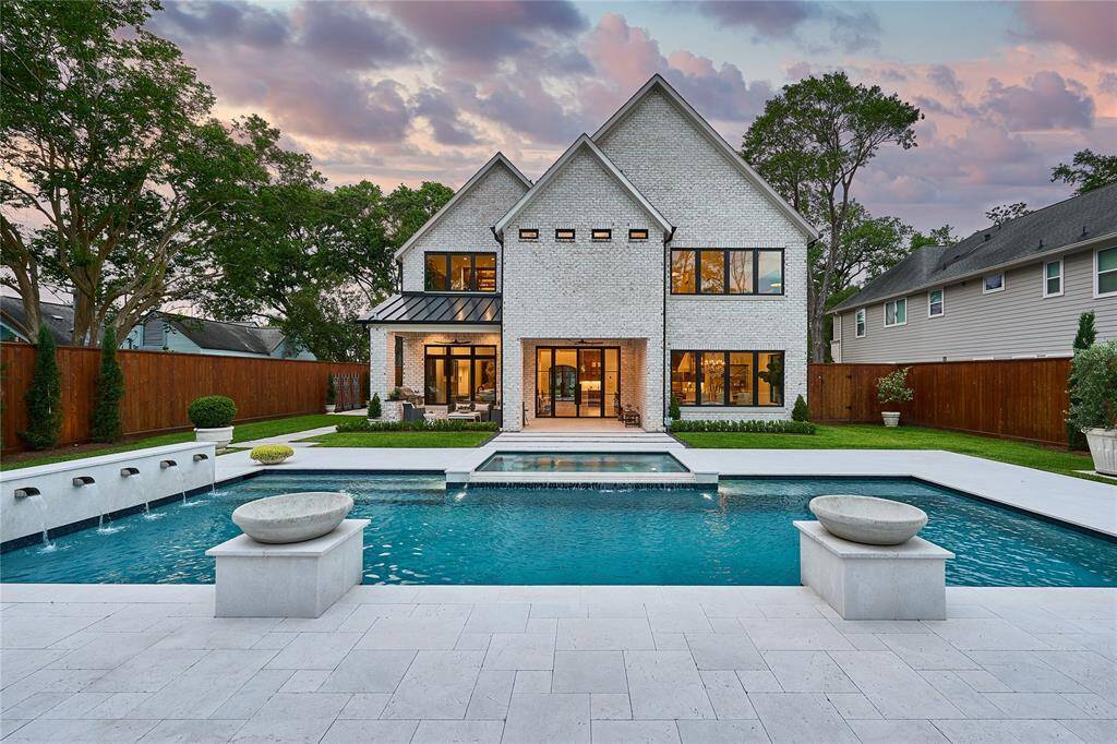 Indulge in your own private oasis with a resort-style backyard, showcasing a custom-designed pool and spa.