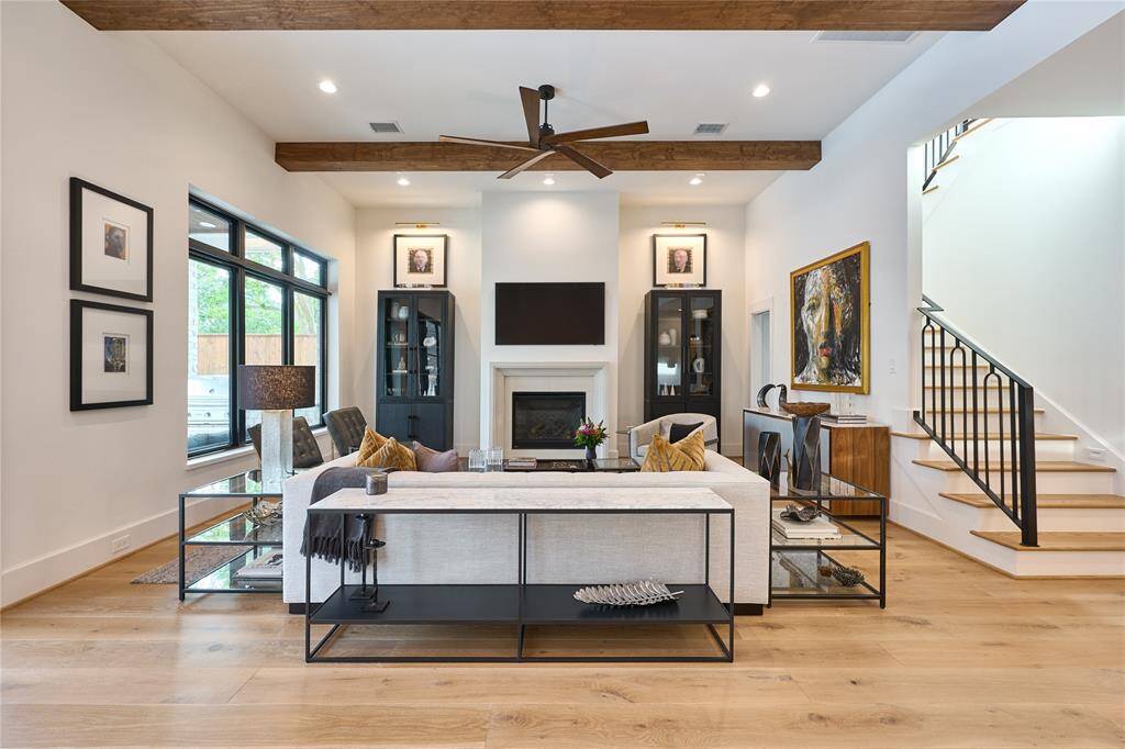 Elegant gas-powered cast stone fireplace in the living room, providing both warmth and a striking focal point.