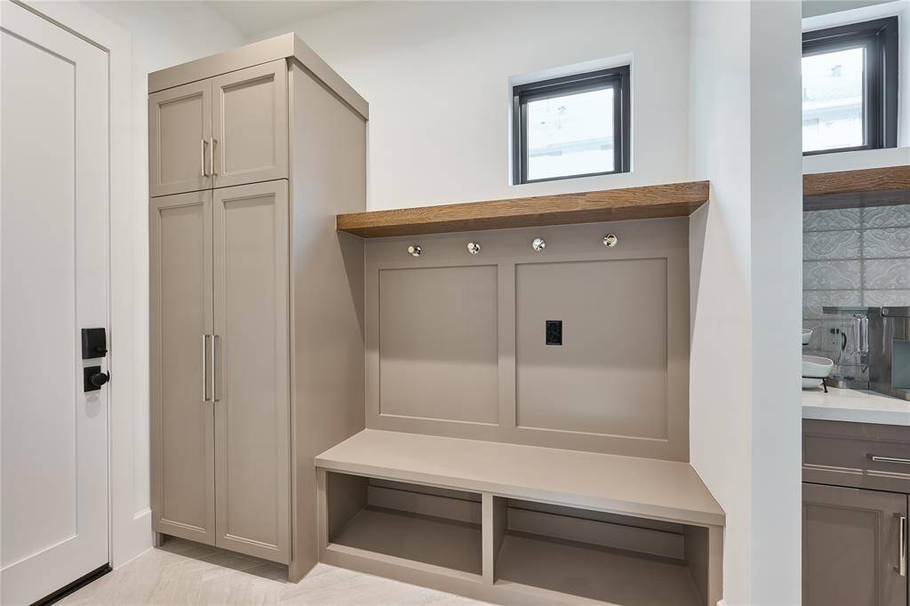 Convenient mudroom located just off the kitchen and garage, offering an organized space for everyday essentials.