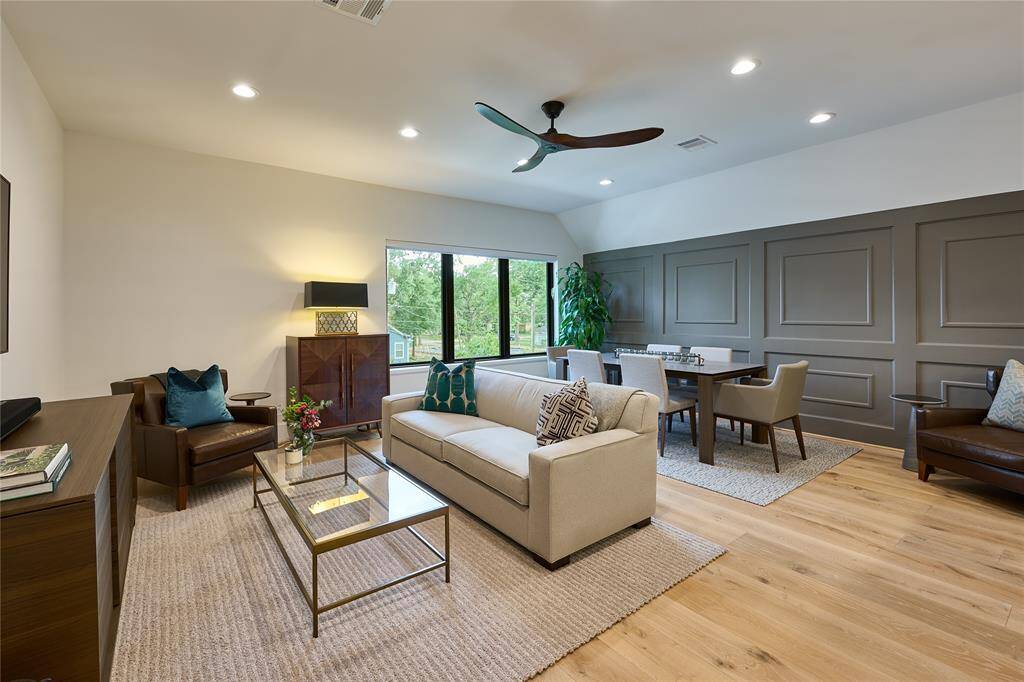Expansive windows in the game room offer stunning views of the pool, complete with remote-controlled shades for ultimate comfort and convenience.