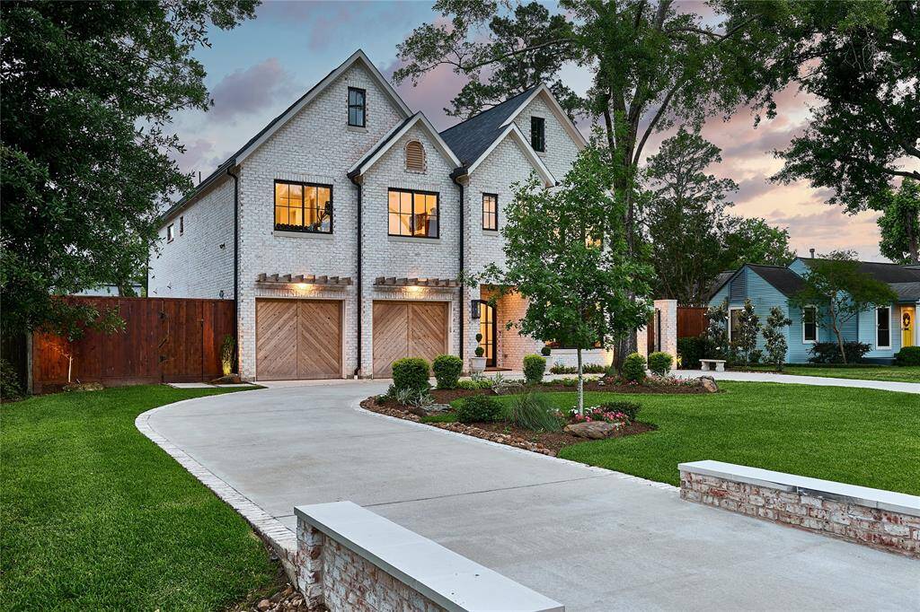 Circle driveway with ample guest parking, complemented by a spacious two-car garage
