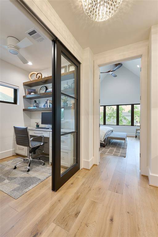 Additional office space located just off the primary bedroom, featuring sleek floating solid oak shelves, combining functionality with sophisticated design.