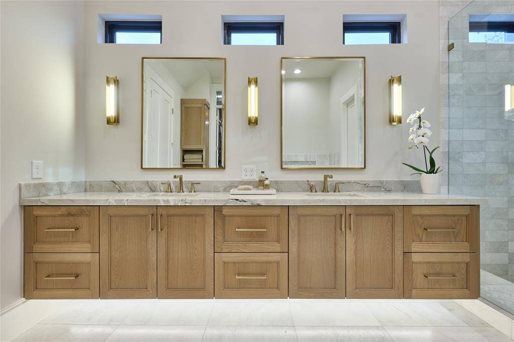 Elegant primary bathroom featuring a floating vanity with pristine Blanco Superiore quartz countertops, blending modern design with luxury.