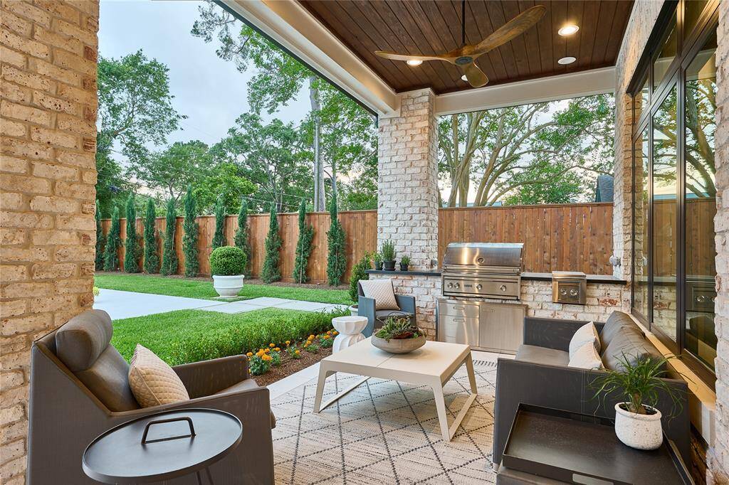 The outdoor kitchen features a premium 36” Lynx grill, convenient side burners, and luxurious leathered granite countertops—designed for the ultimate outdoor cooking experience.