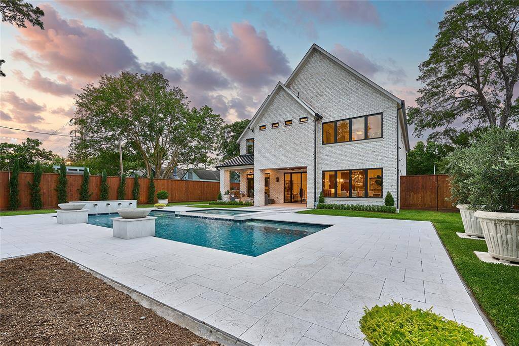 Back patio and pool surround finished in elegant white travertine—Caesar’s Palace-grade—offering timeless beauty and a resort-style aesthetic.