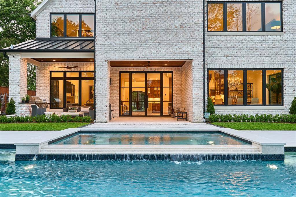 Featuring a large heated spa and a beautifully finished PebbleTec pool, this outdoor oasis is designed for both relaxation and durability.