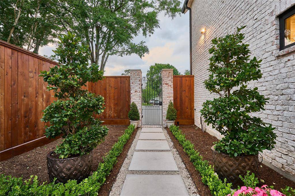 Striking statement-piece courtyard on the side of the home, offering a unique blend of style, privacy, and outdoor charm.