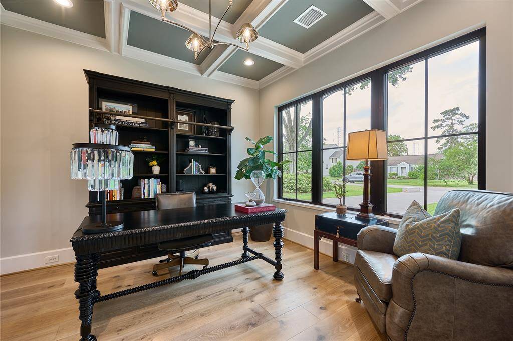 Sophisticated home office just off the entry, featuring expansive windows that flood the space with natural light.