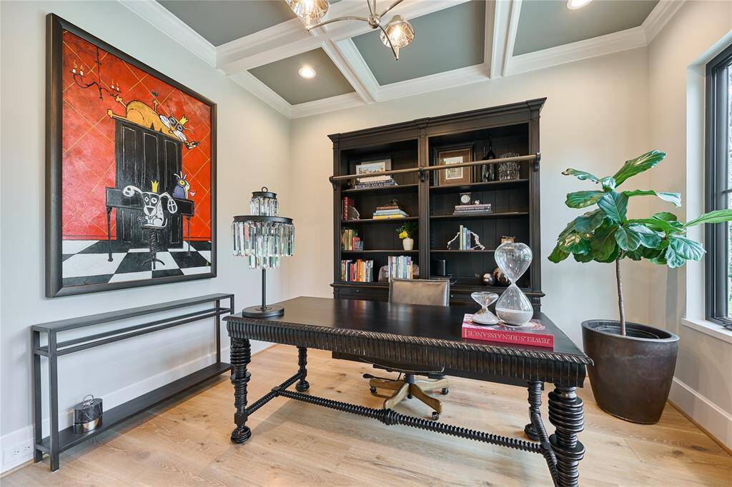 The office showcases elegant coffered ceilings, adding depth and architectural detail to this light-filled workspace.
