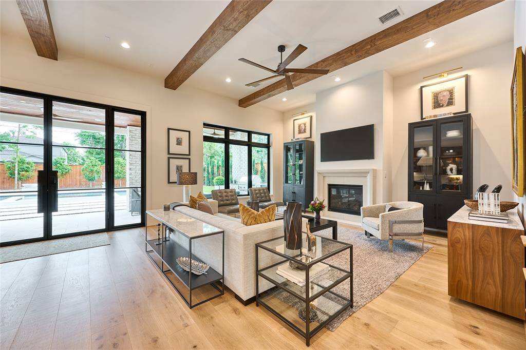 Spacious living room with soaring 12-foot ceilings, complemented by a custom Ready Door backdoor, blending style and functionality.