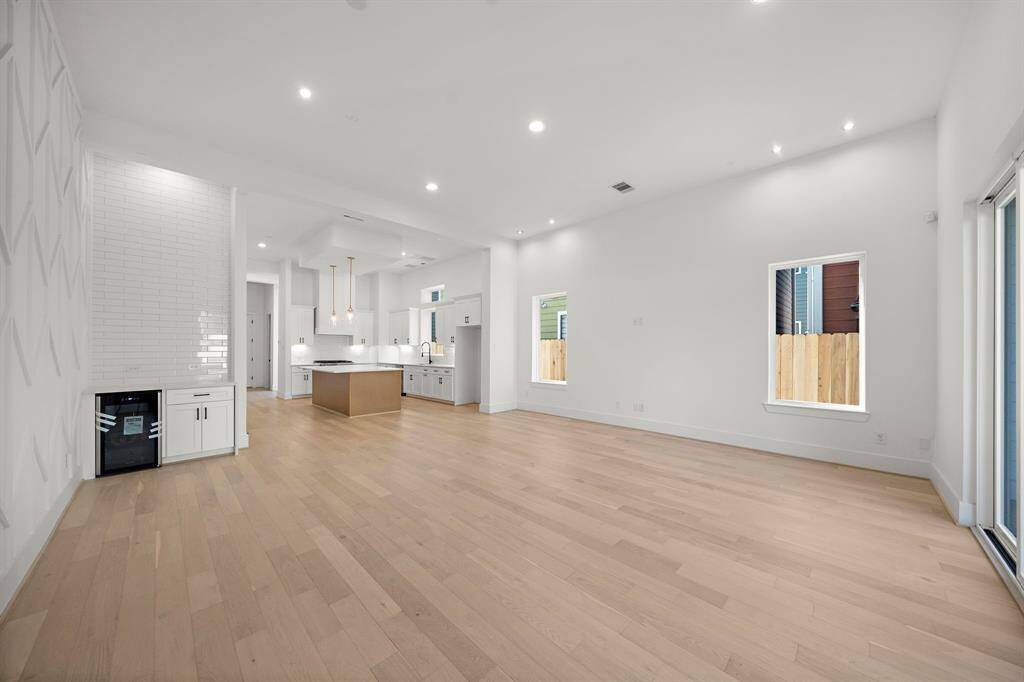 Living/dining room also features a convenient bar area with wine cooler and additional storage! (Photo is of a previously completed home.)