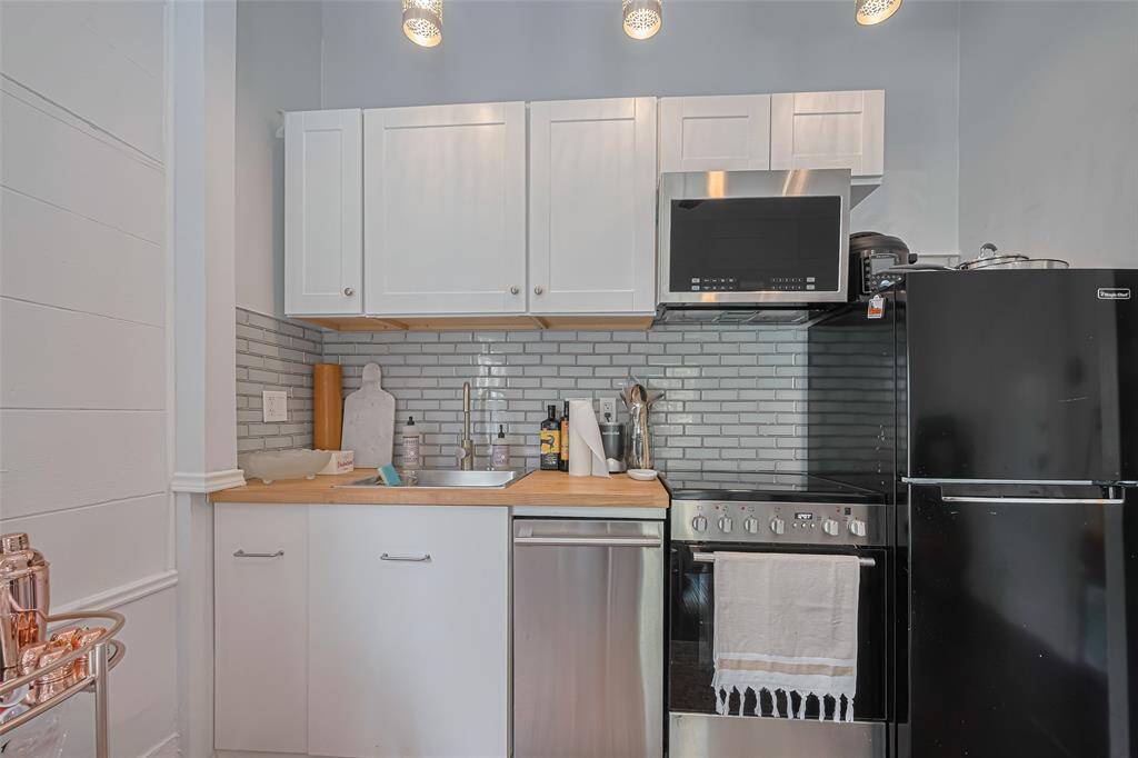 Kitchen boasts storage and all appliances.