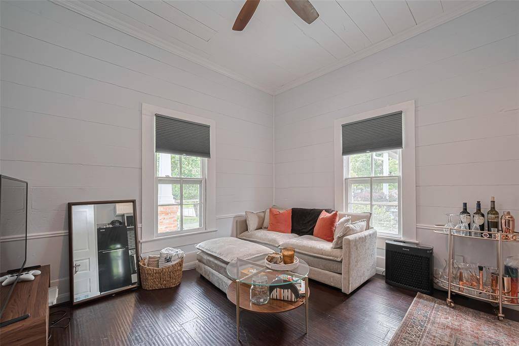 Enjoy spacious living area with high ceilings and hardwood flooring.
