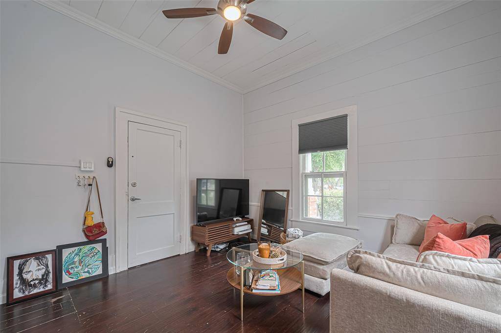 Adjacent view of living room area with an abundance of nature lighting.
