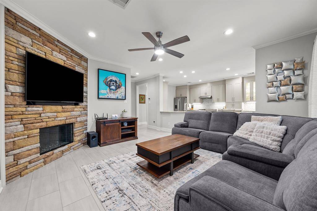 Stunning open floor plan featuring a beautiful fireplace, seamlessly connected to the kitchen—perfect for entertaining.