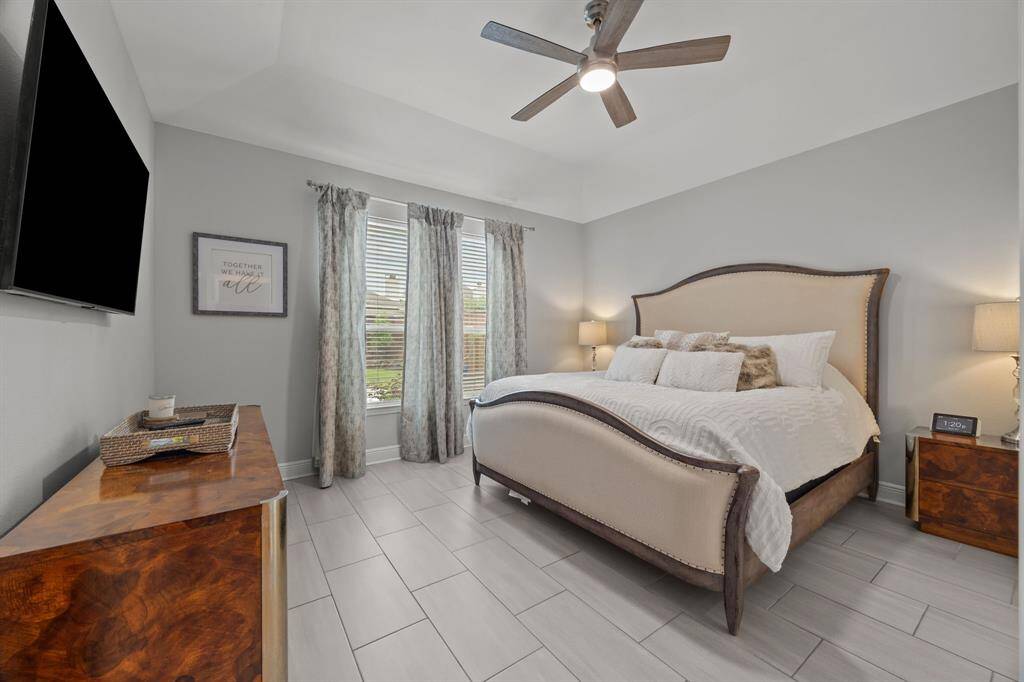 The spacious and light-filled layout continues with a luxurious primary suite located on the main floor.
