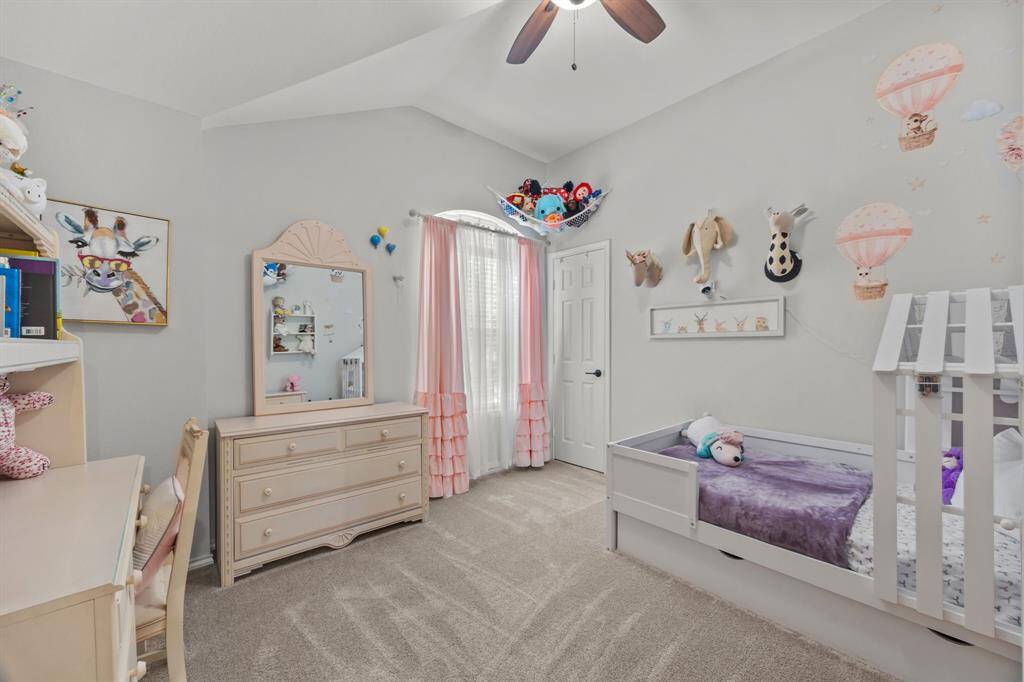 Bright third bedroom with abundant natural light and soft neutral tones.
