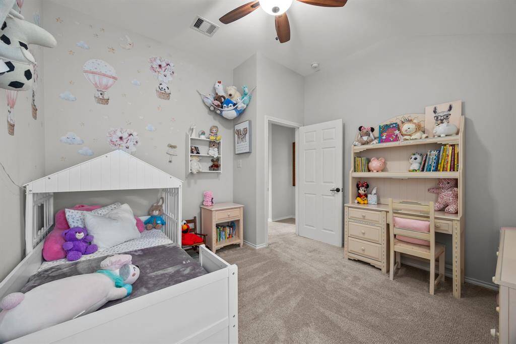 Charming third bedroom with cozy carpeting, ideal for a child's room or home office.