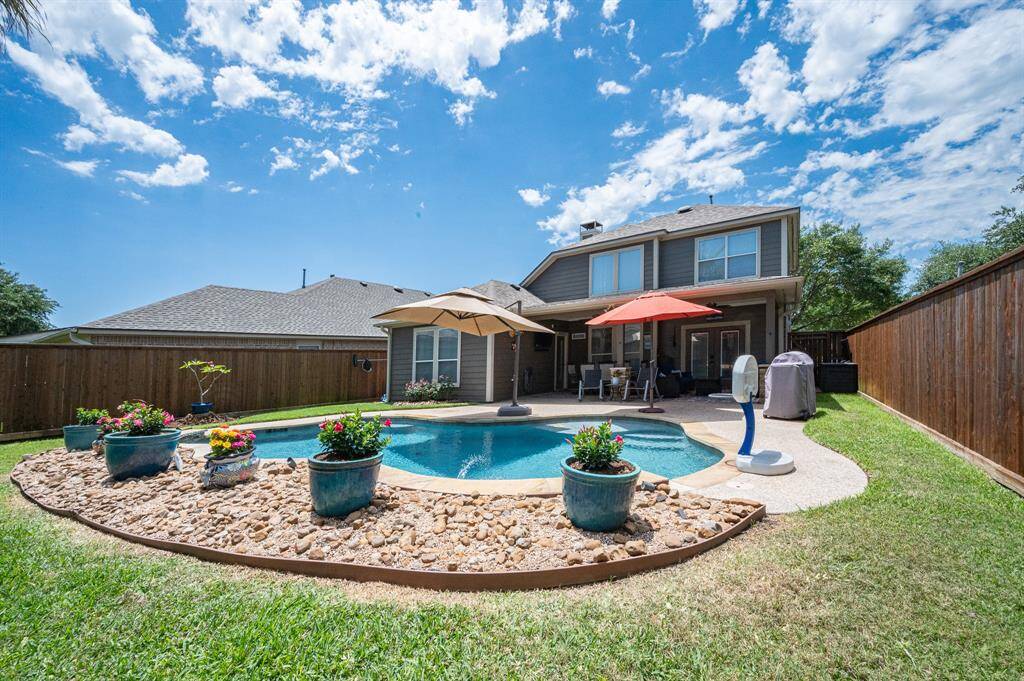 Enjoy year-round entertaining in this inviting backyard oasis.