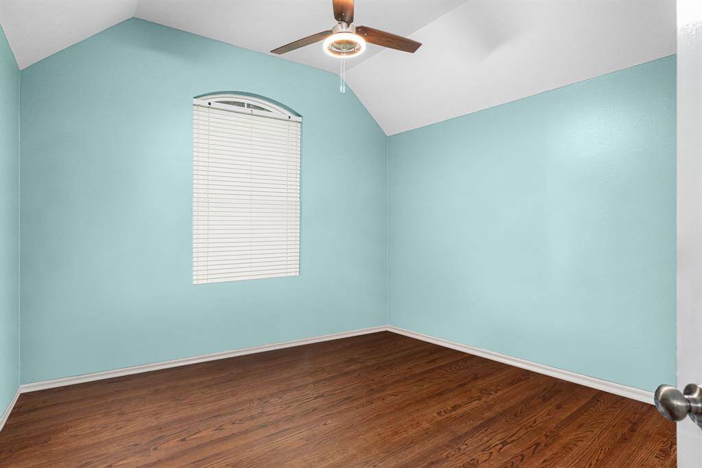 Second Bedroom with soaring ceilings and large window overlooking the front yard. Large closet and ceramic tile throughout.