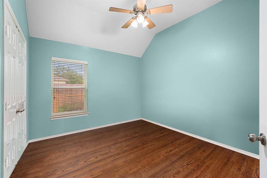 Third bedroom with soaring ceilings and large window overlooking the side yard. Large closet