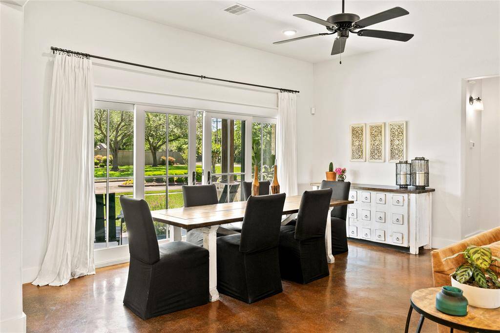 Dining room with french sliding doors that open to the front porch letting in fresh air and tons of natural light.