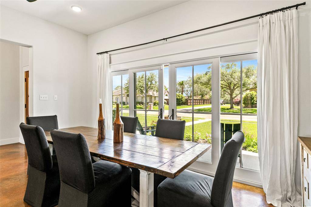 Dining room with french sliding doors that open to the front porch letting in fresh air and tons of natural light.