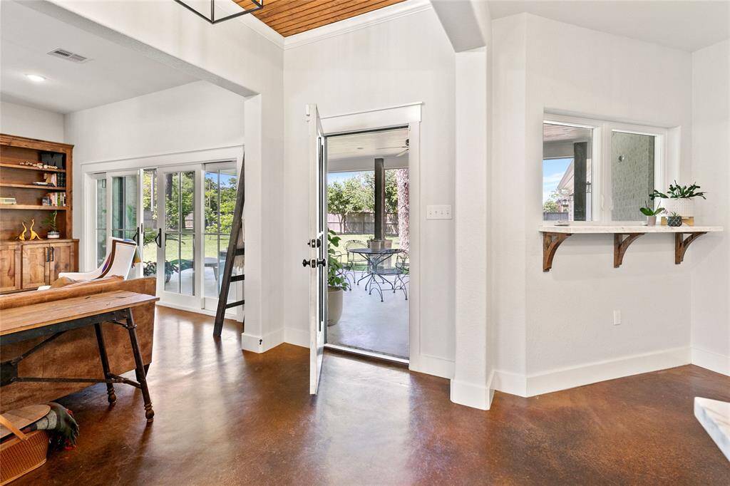 Pass though window, back door, and sliding french doors all open up to the back porch.