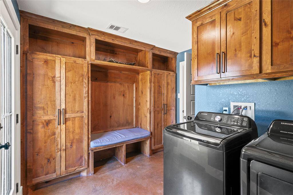 Landry room with custom built in cabinets.