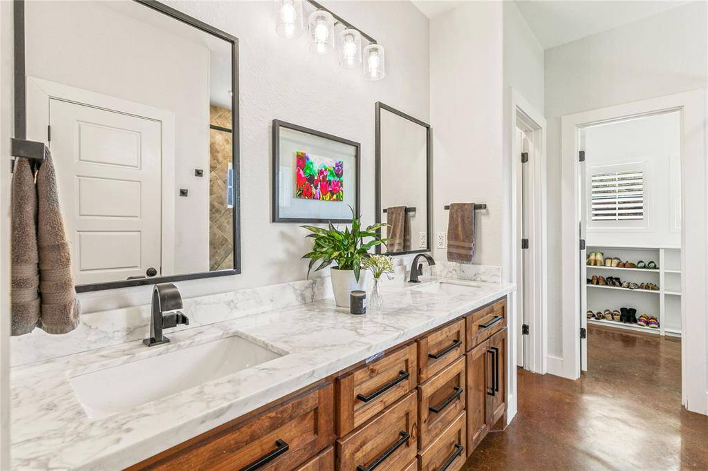 Primary bathroom with large walk in shower, water closet, linen closet, and walk-in closet.