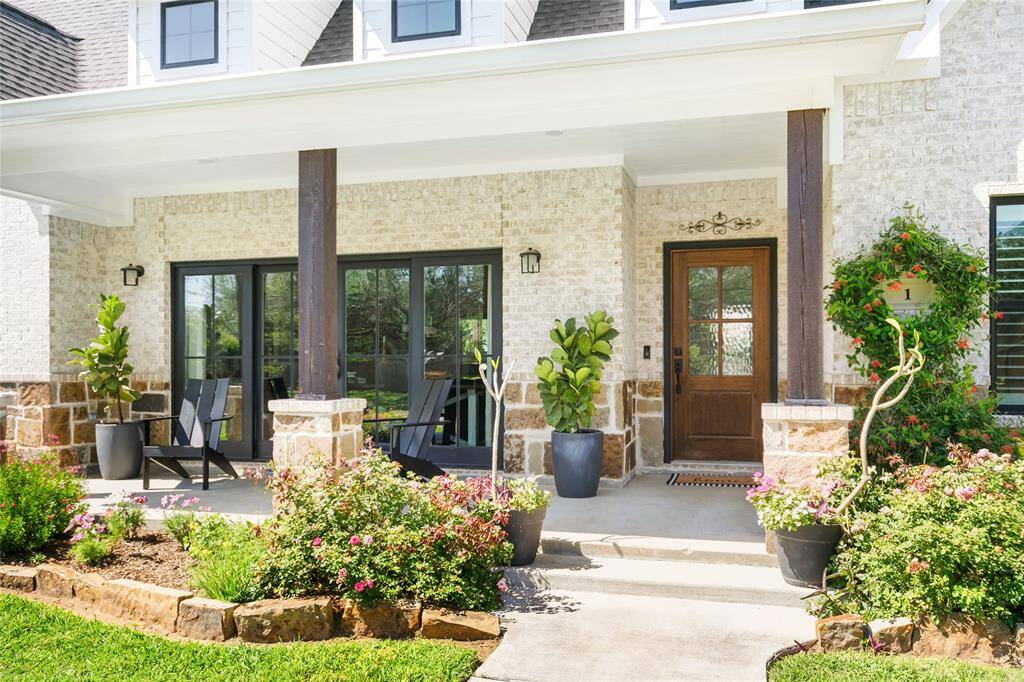 Large front porch with sliding french doors off the dining room that open up and overlook the beautifully landscaped front yard.