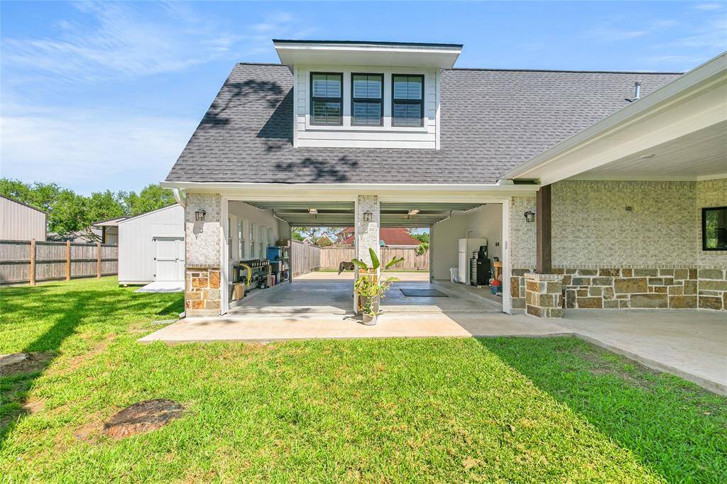 Two car garage that opens up to the driveway and backyard for convenience and a great cross breeze. For added convenience, you have access to the half bathroom from inside the garage.