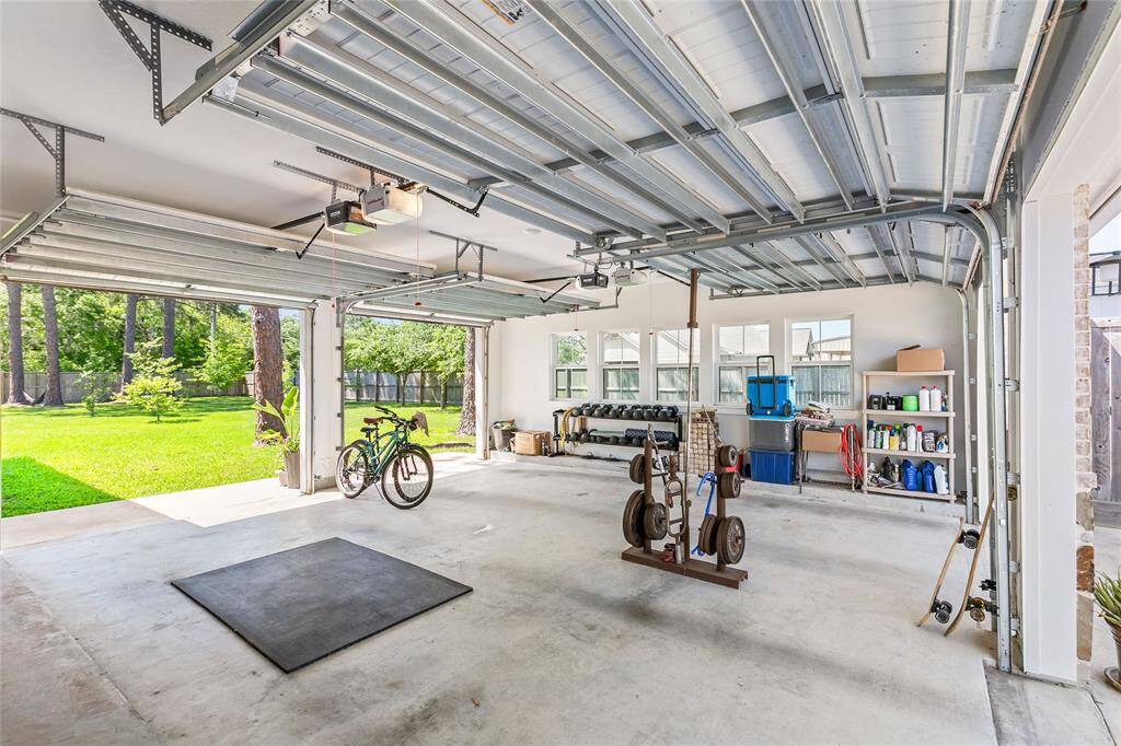 Two car garage that opens up to the driveway and backyard for convenience and a great cross breeze. For added convenience, you have access to the half bathroom from inside the garage.