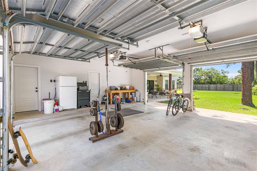 Two car garage that opens up to the driveway and backyard for convenience and a great cross breeze. For added convenience, you have access to the half bathroom from inside the garage.