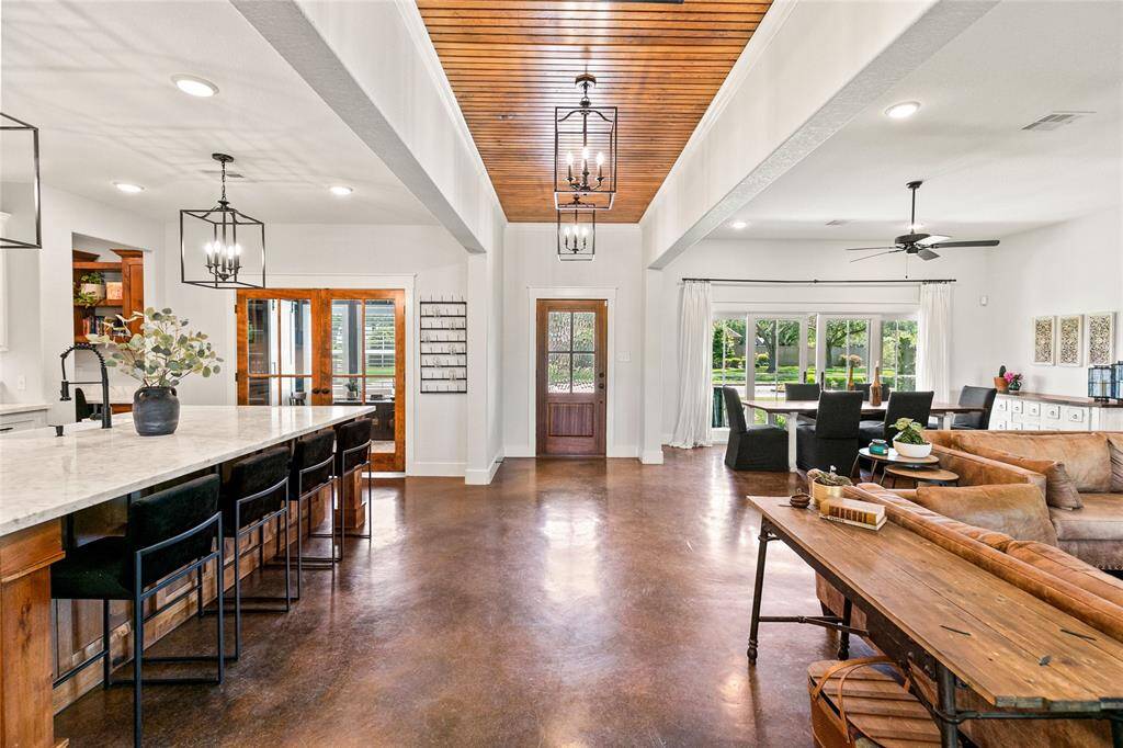 Entry way with gorgeous ceiling detail and stained concrete floors.
