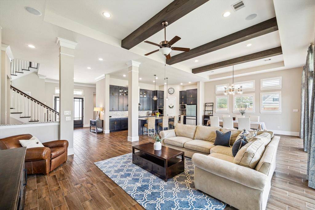 You are invited to tour this stunning former David Weekley model home, where exceptional design meets modern luxury. Some of our favorite features include elegant wood-look tile flooring, soaring 12' ceilings, rich wood ceiling beams, wood-shuttered windows, expansive sliding glass doors in the family room, a spectacular island kitchen, and a luxurious owner's retreat. But that’s just the beginning—come see for yourself, there’s so much more to discover!
