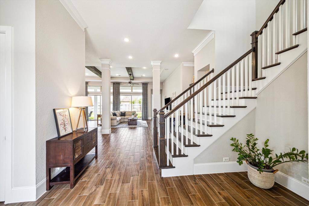 From the front door to the back, this home is filled with elegant finishes and unique features designed to impress. Some of our favorites include soaring 12' ceilings, stylish wood-look tile flooring, custom built-ins, chic lighting and fans, striking wood ceiling beams, and disappearing sliding glass doors that seamlessly open to the covered patio. And there’s even more to love—come see for yourself!