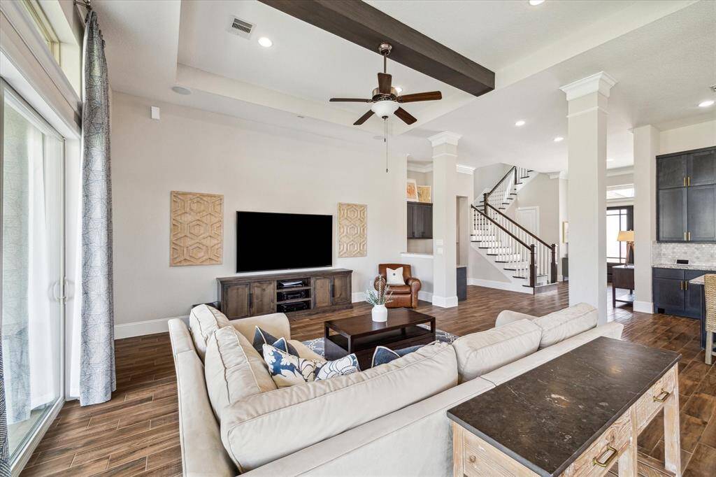 Flooded with natural light from a striking wall of sliding glass doors, the family room provides the perfect balance of comfort and style. This bright and airy space is ideal for everyday living and effortless entertaining, seamlessly connecting indoor and outdoor areas for a welcoming and functional flow.