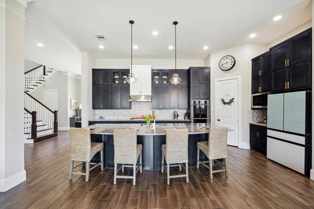 Ditch the takeout and enjoy home cooked meals more often with the help of this beautifully appointed kitchen. With expansive cabinetry, a nearby chef's desk, an oversized island, and large pantry, you'll have plenty of room for all your favorite kitchen gadgets here.