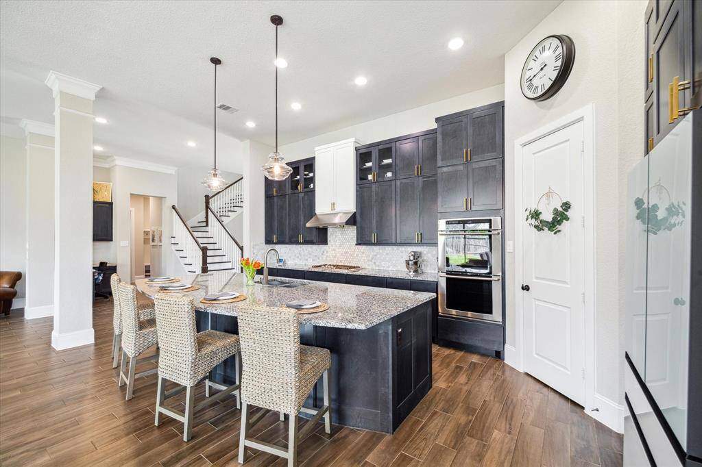 From hosting lavish dinner parties to enjoying casual meals, this kitchen has everything you need. Thoughtfully designed with ample storage, stainless steel appliances, and a spacious island with bar seating, it’s the perfect blend of style and functionality.