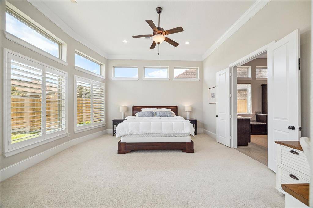 You will have sweet dreams in this luxurious owner's retreat. This spacious suite offers soft neutral finishes, oversized windows with wood shutters and transoms above, a custom walk-in closet and a specular ensuite bathroom.